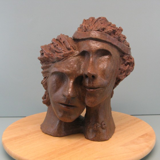 Enmashed couple. Made of Terracotta.11.5 H by 28  inch perimeter